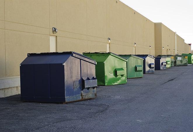 bright yellow construction dumpster full of discarded materials in Freeport